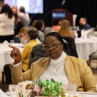 person at table pointing